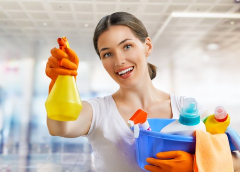 Domestic cleaner preparing a tidy living room in Belsizepark